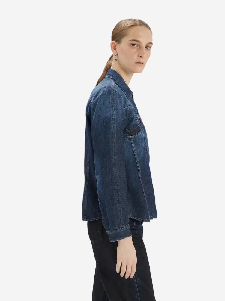 Person wearing a blue denim jacket on a white background