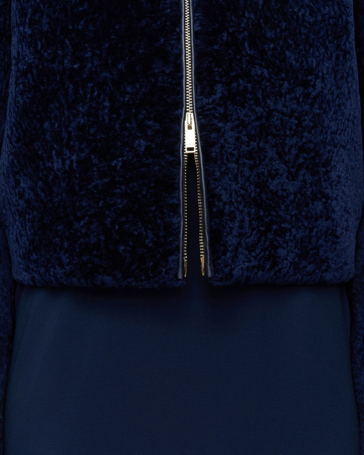 Close-up of the textured short-haired shearling and gold zip at the hem of the JOSEPH Liris jacket