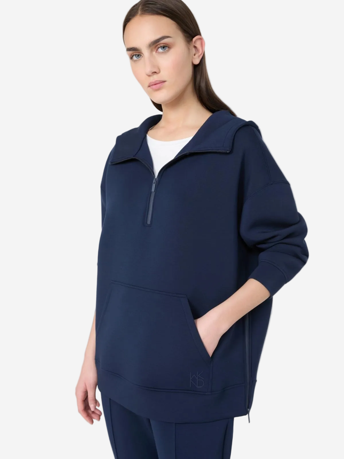 Woman wearing a navy blue outfit with a white background