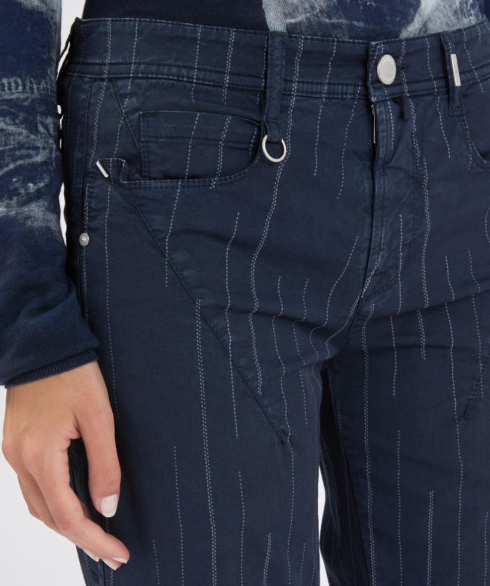 Navy pinstripe pants with a close-up of a pocket and button.