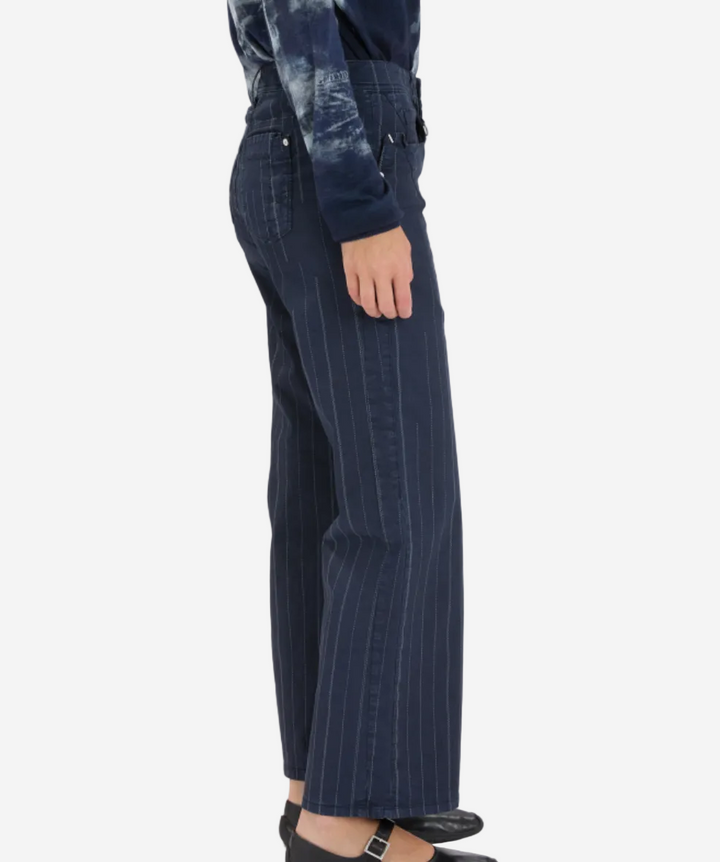 Person wearing dark blue pinstripe pants on a white background