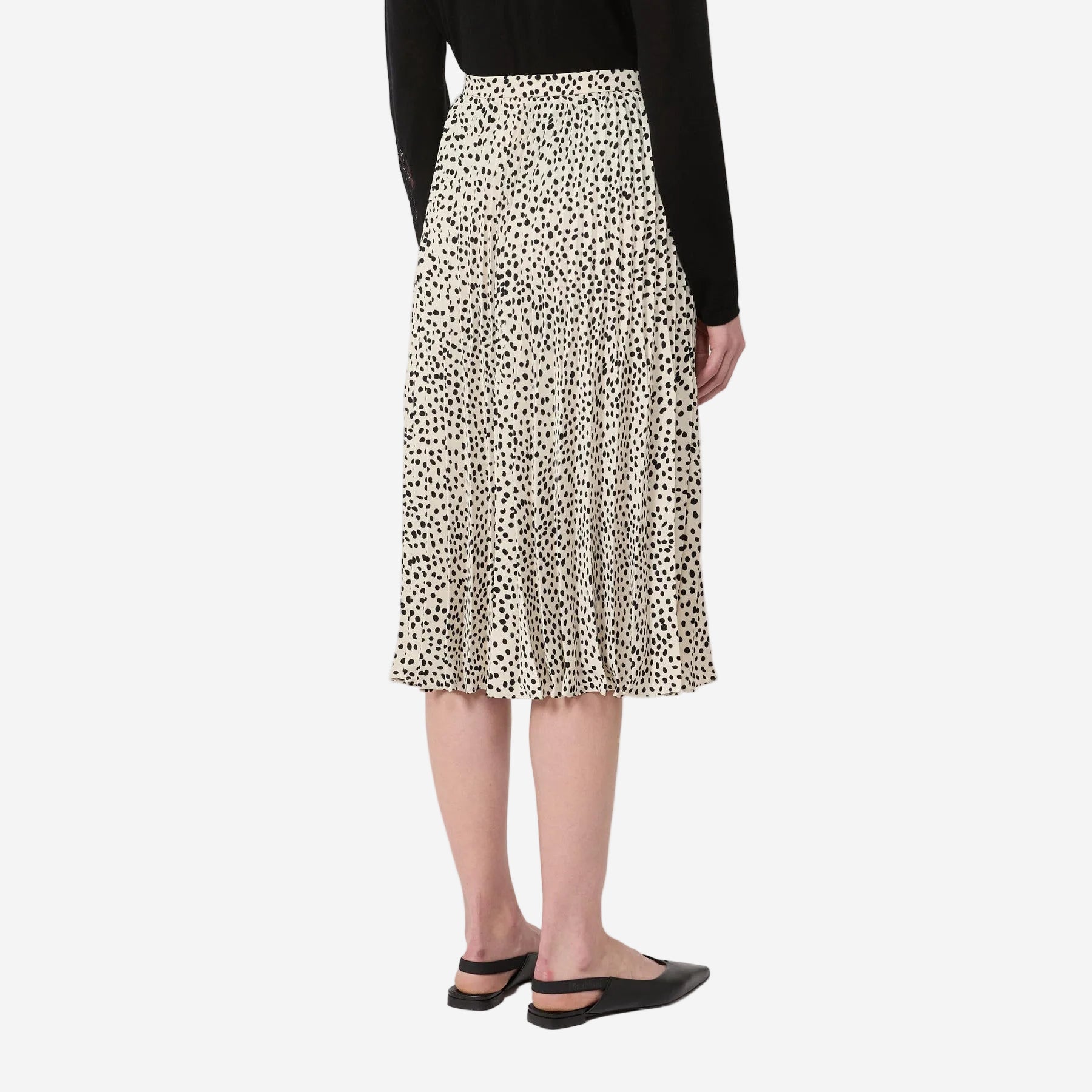 Person wearing a leopard print skirt on a white background