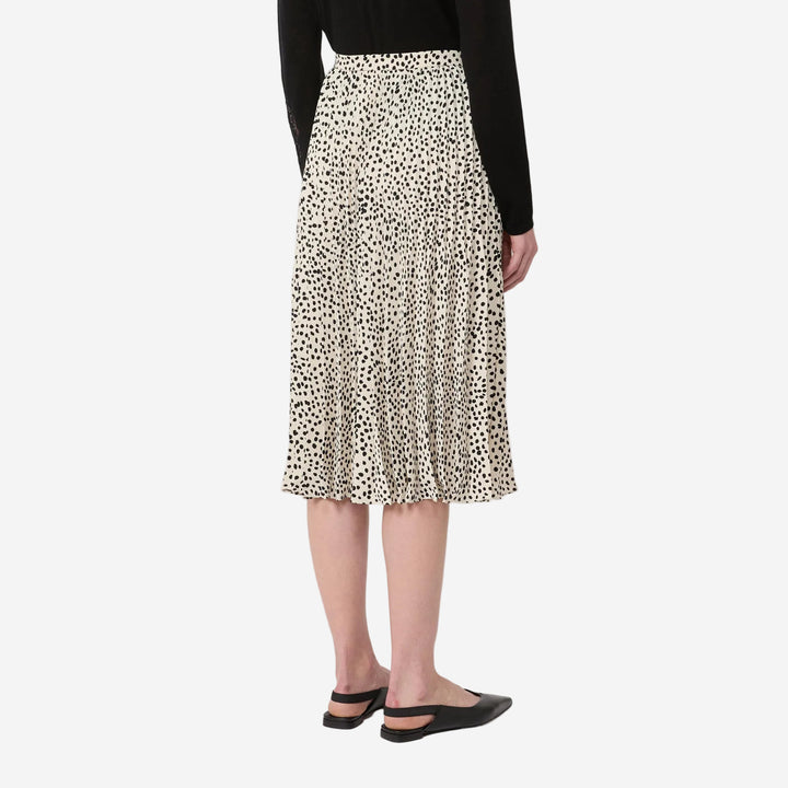 Person wearing a leopard print skirt on a white background