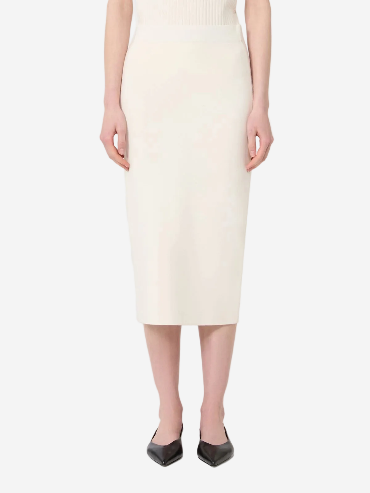 Person wearing a white knee-length skirt on a plain background