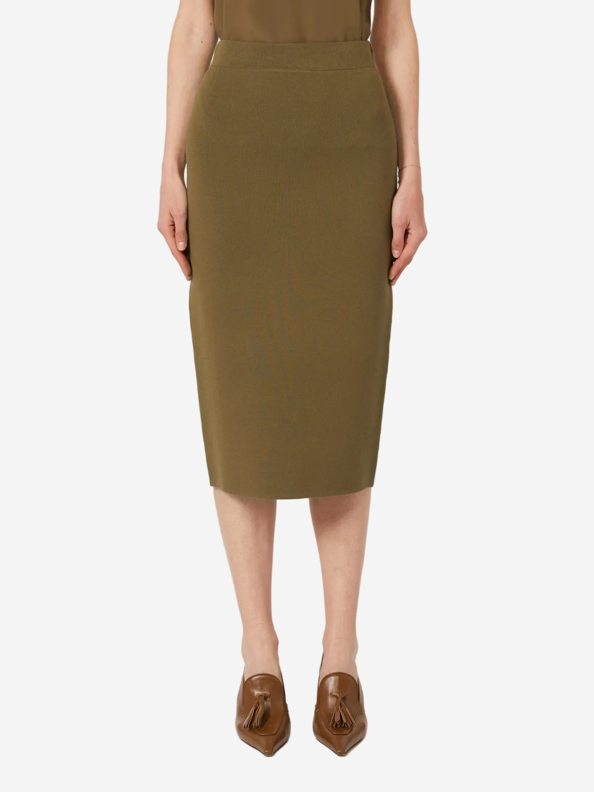 Person wearing a green skirt and brown shoes on a white background