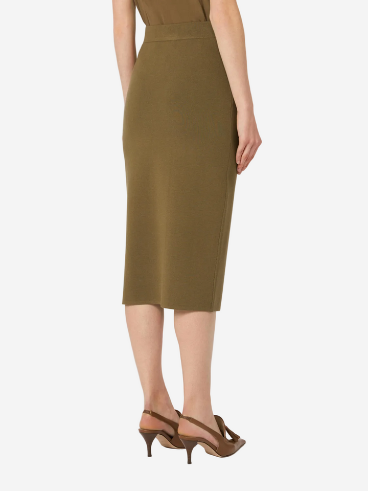 Person wearing a green dress on a white background