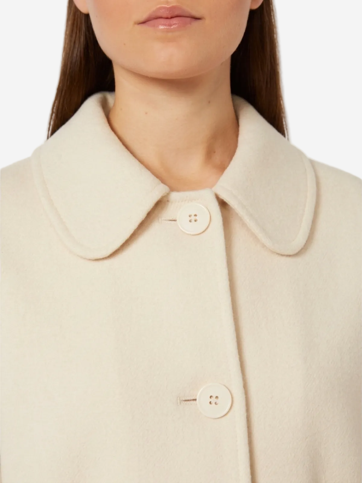 Close-up of a beige coat with buttons on a white background