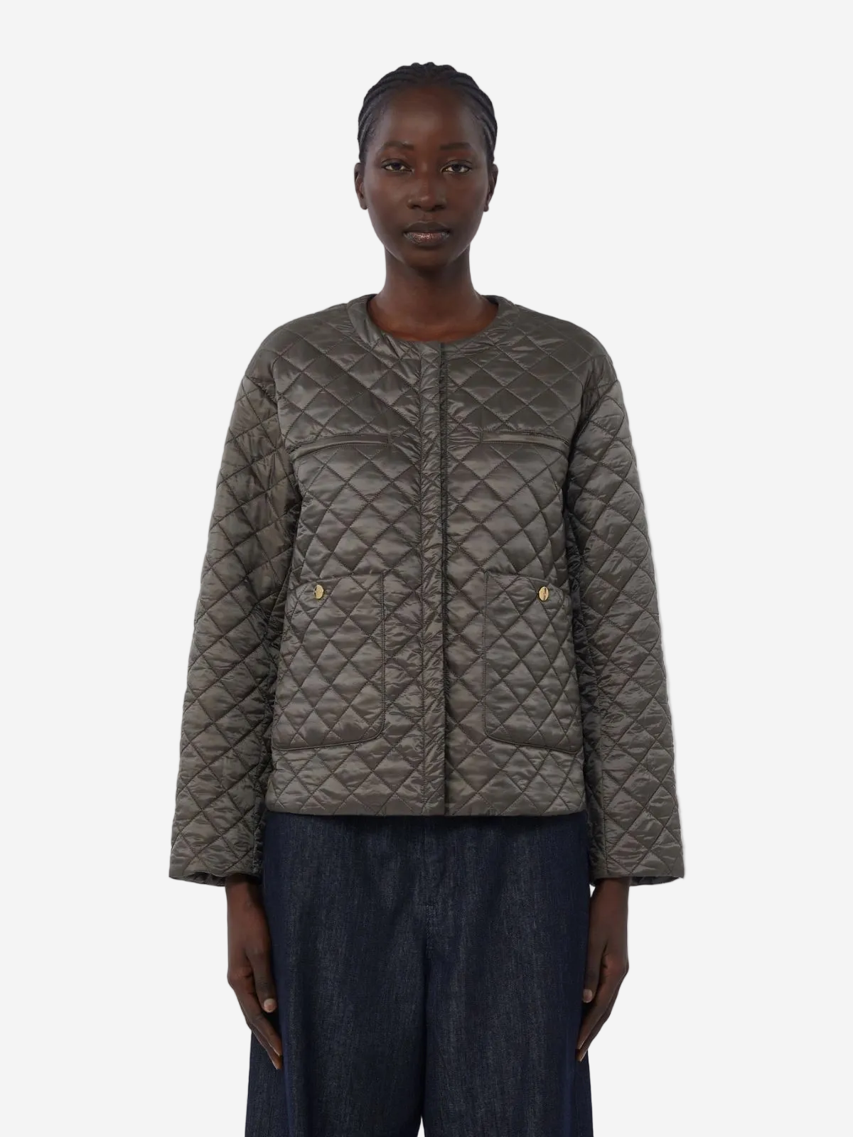 Person wearing a quilted jacket on a white background