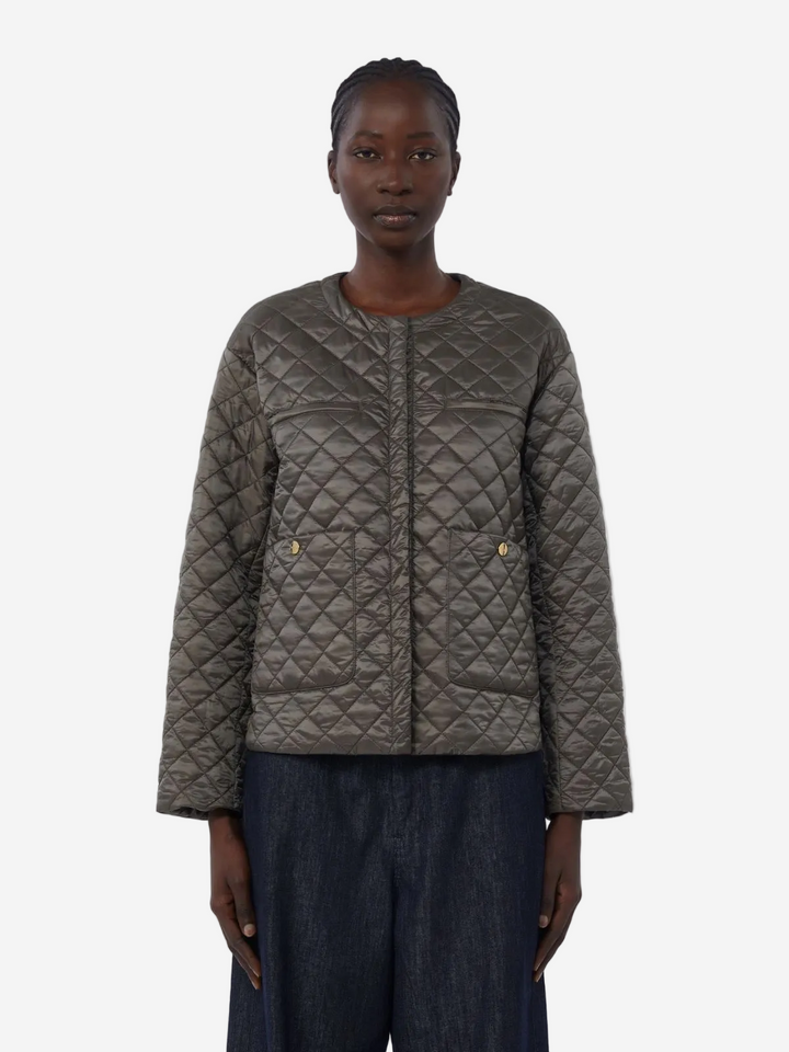 Person wearing a quilted jacket on a white background