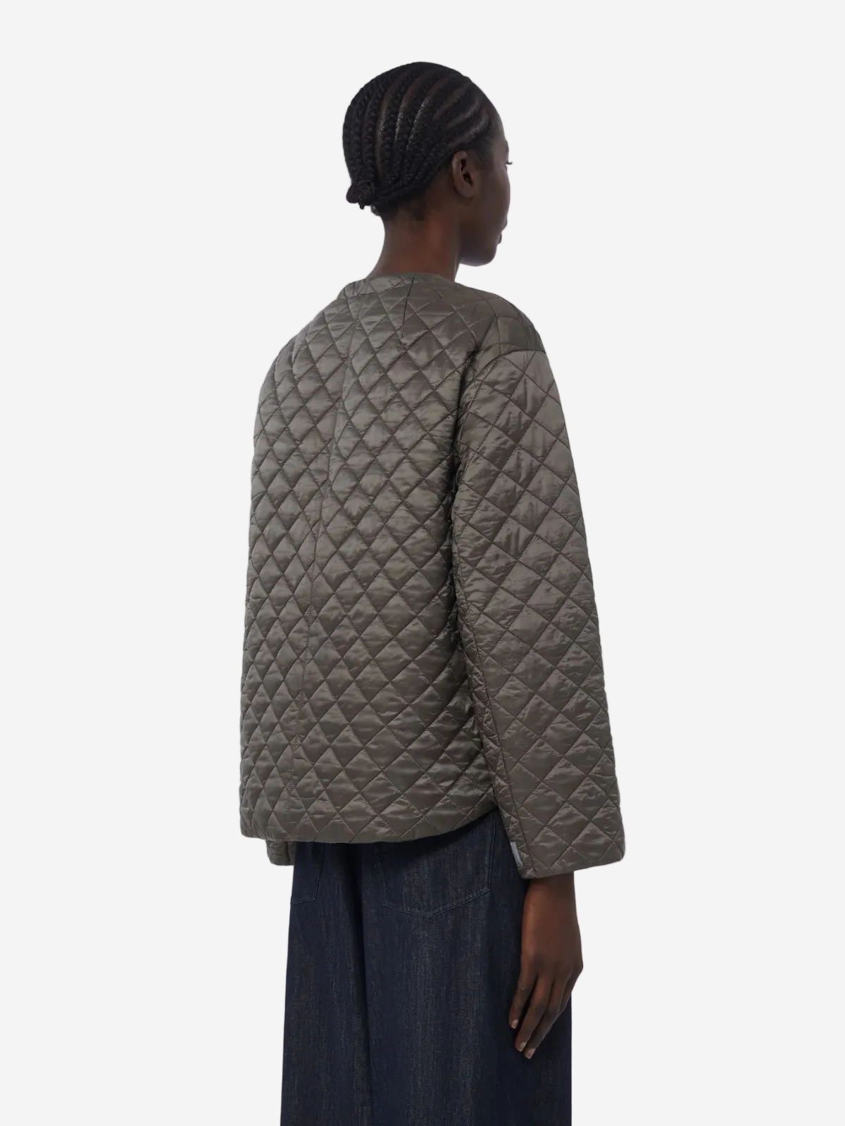 Person wearing a quilted jacket on a white background