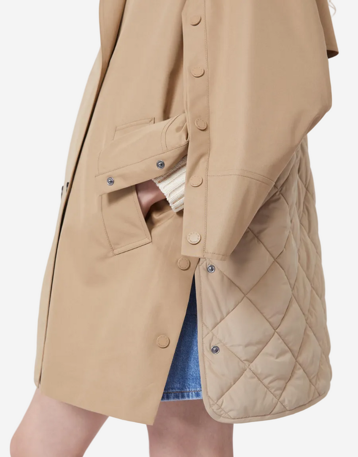 Beige quilted jacket with a white background