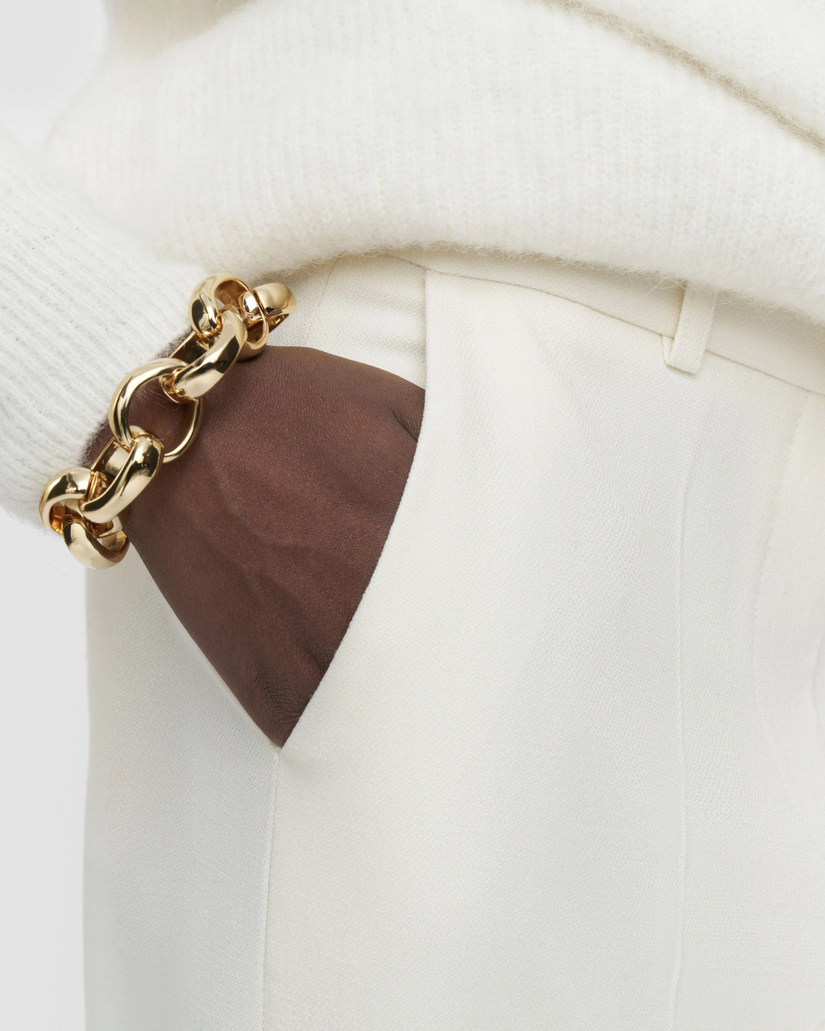 Close-up of the welt pocket and textured ivory fabric on the JOSEPH Mitae trousers