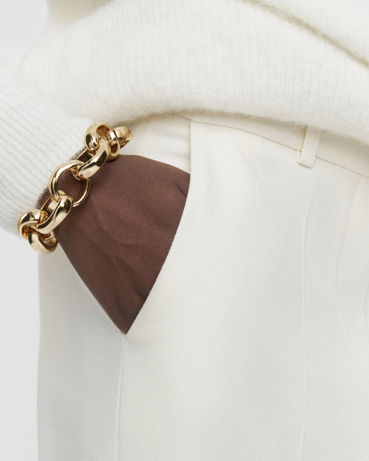 Close-up of the welt pocket and textured ivory fabric on the JOSEPH Mitae trousers