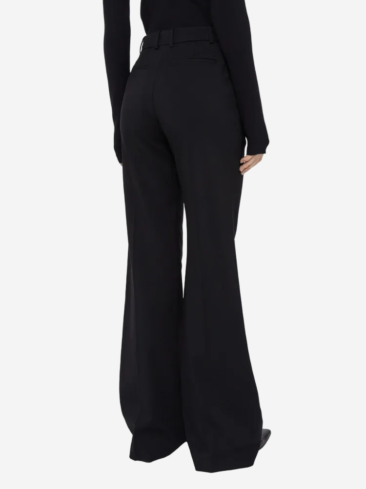Black wide-leg pants worn by a person on a white background