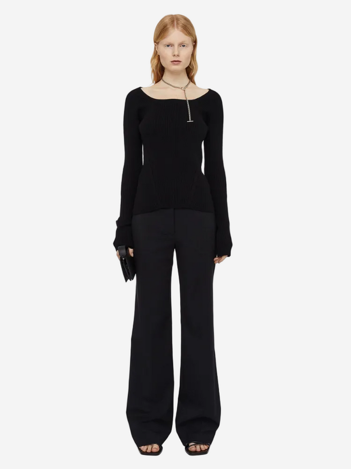 Woman wearing a black outfit on a white background