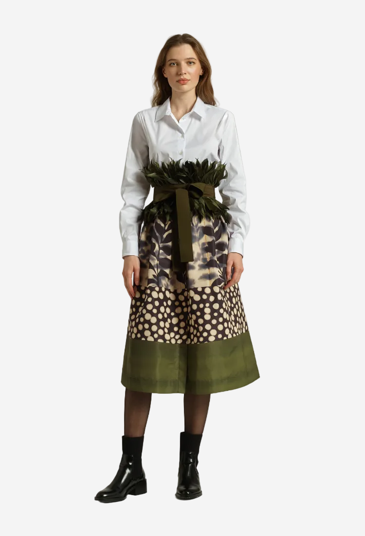 Model in a greem dress with feather belt