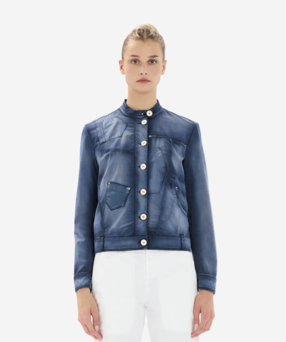 Woman wearing a blue denim jacket with white buttons on a white background