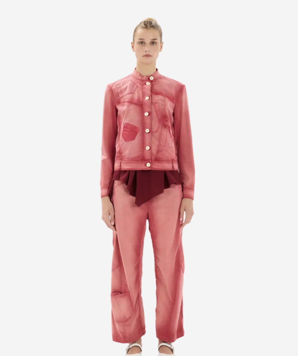 Woman wearing a pink outfit with a matching jacket and pants on a white background