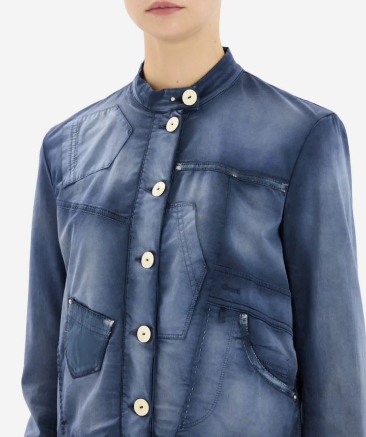 Blue denim jacket with button details on a white background