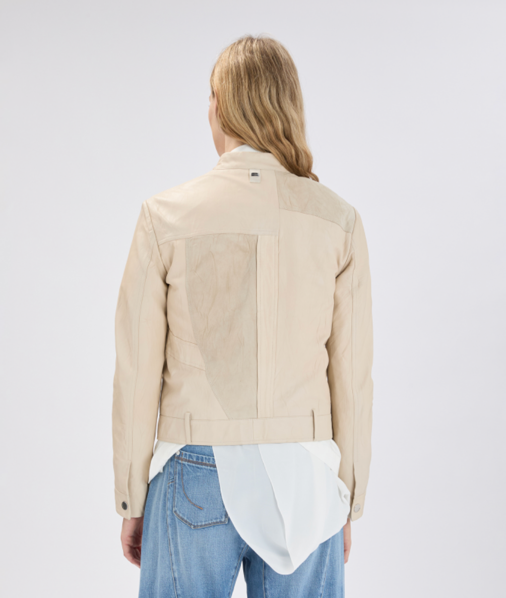 Person wearing a beige jacket on a white background