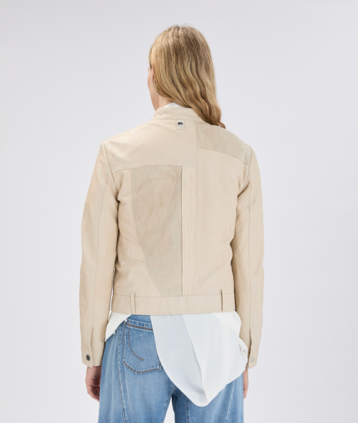 Person wearing a beige jacket on a white background