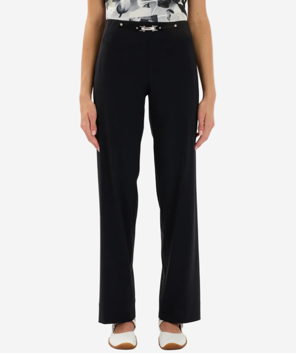 Person wearing black pants on a white background