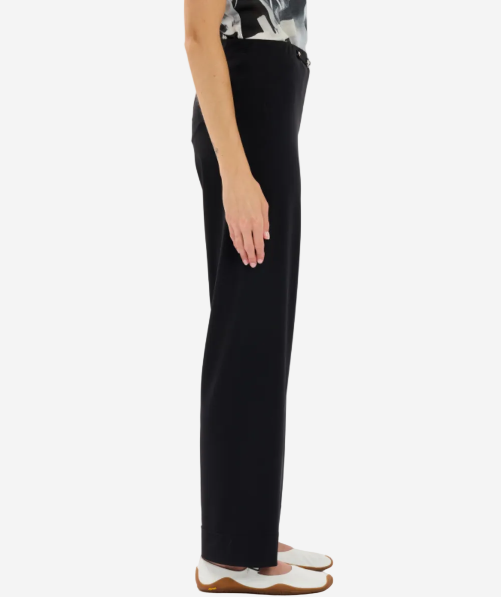Person wearing black pants on a white background