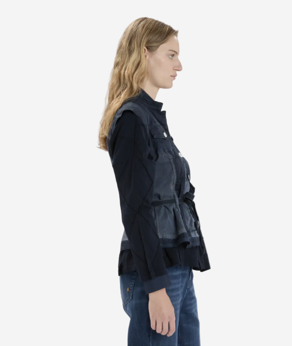 Woman wearing a dark jacket and jeans on a white background