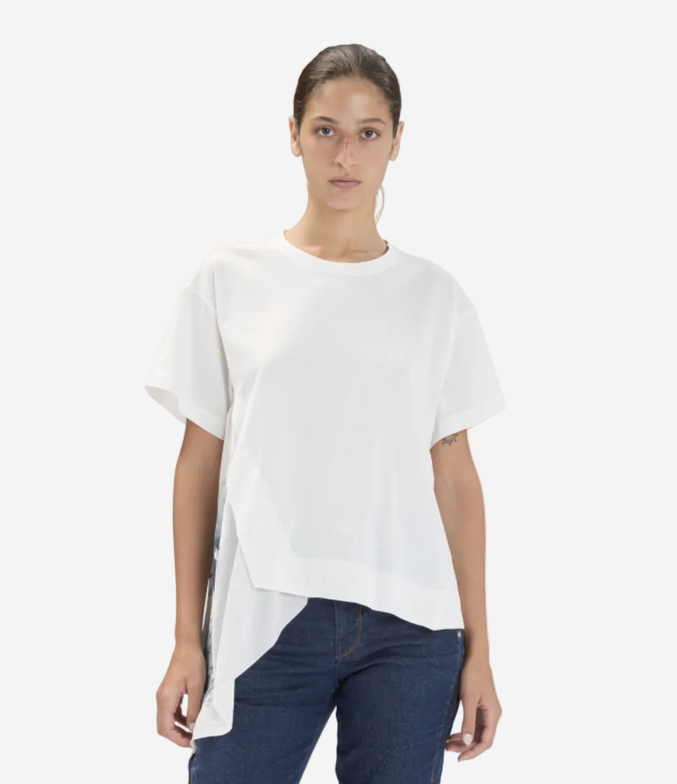 Woman wearing a white t-shirt and blue jeans on a plain background