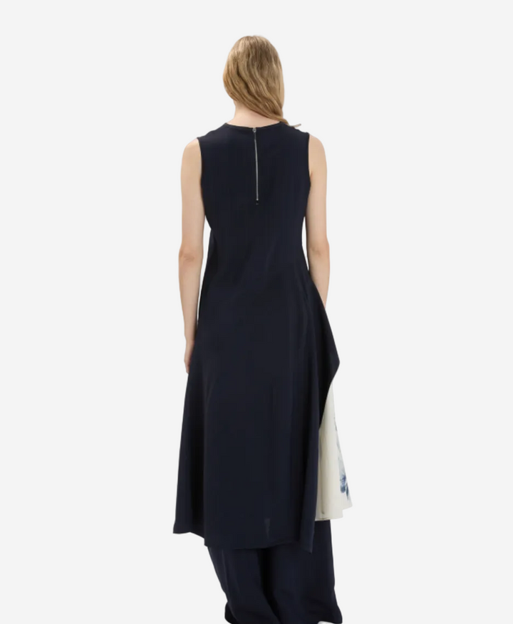 Woman wearing a black sleeveless dress with a white background