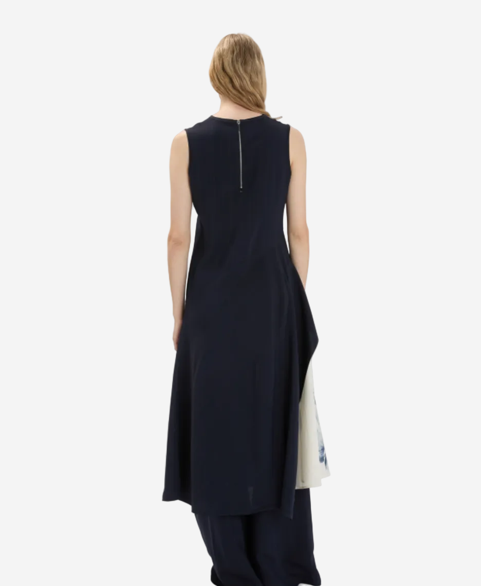 Woman wearing a black sleeveless dress with a white background