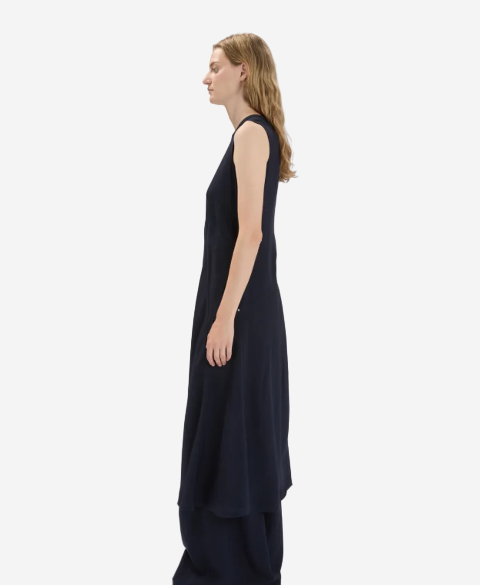 Woman wearing a black sleeveless dress on a white background