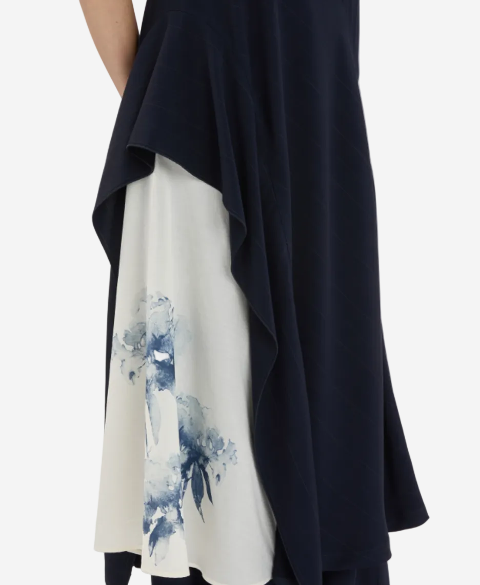 Navy and white dress with abstract blue design on a plain background