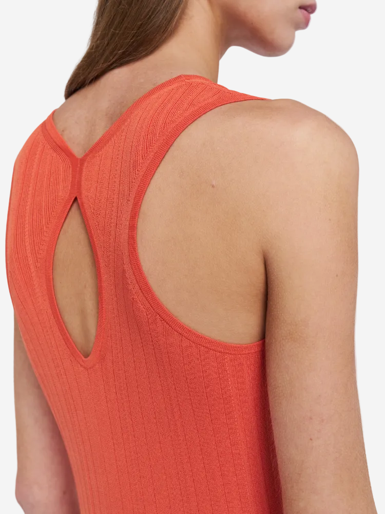 Close-up of a person wearing an orange sleeveless top with a cut-out back design.