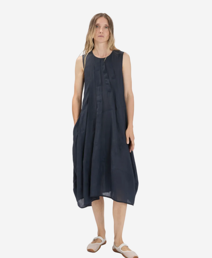 Woman wearing a black sleeveless dress on a white background