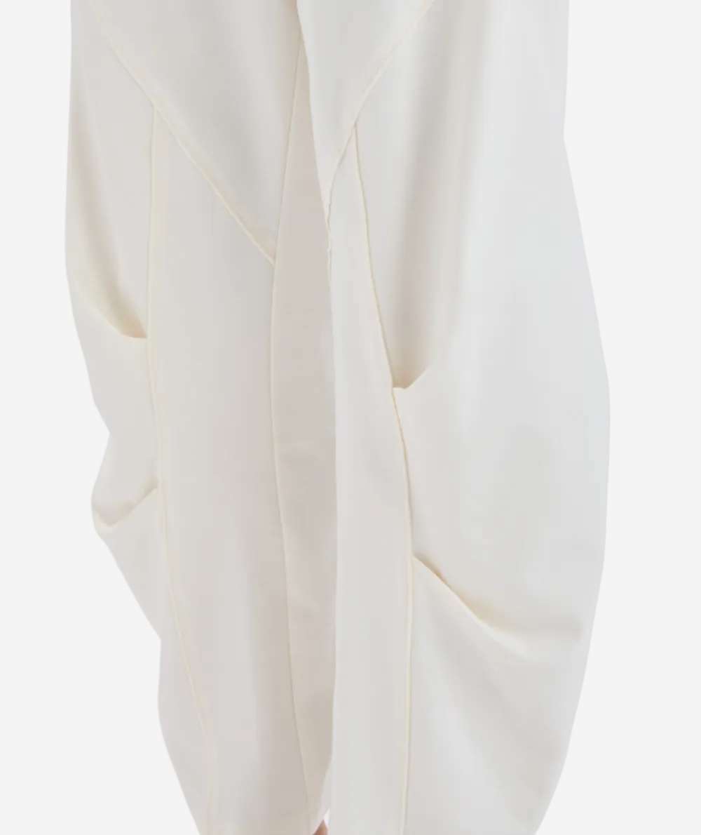 Close-up of a white garment with a subtle pattern on a light gray background