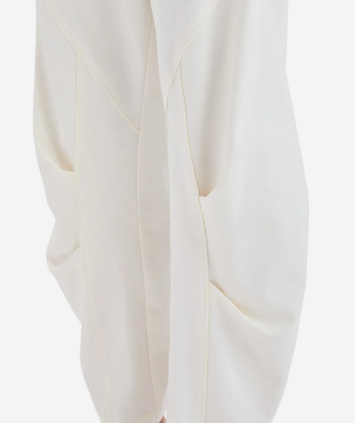 Close-up of a white garment with a subtle pattern on a light gray background