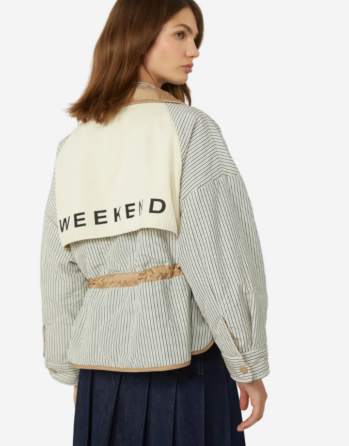 Woman wearing a striped shirt with a 'Weekend' towel draped over her shoulder on a white background