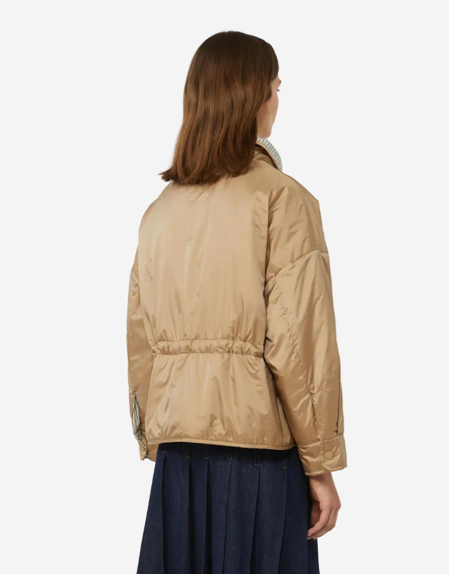 Person wearing a beige puffer jacket on a white background