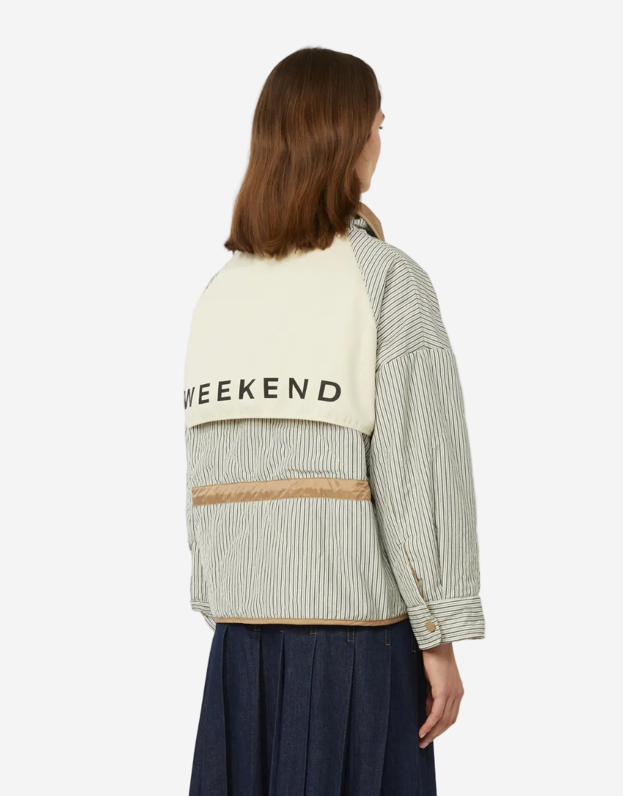 Person wearing a jacket with 'Weekend' text on a white background