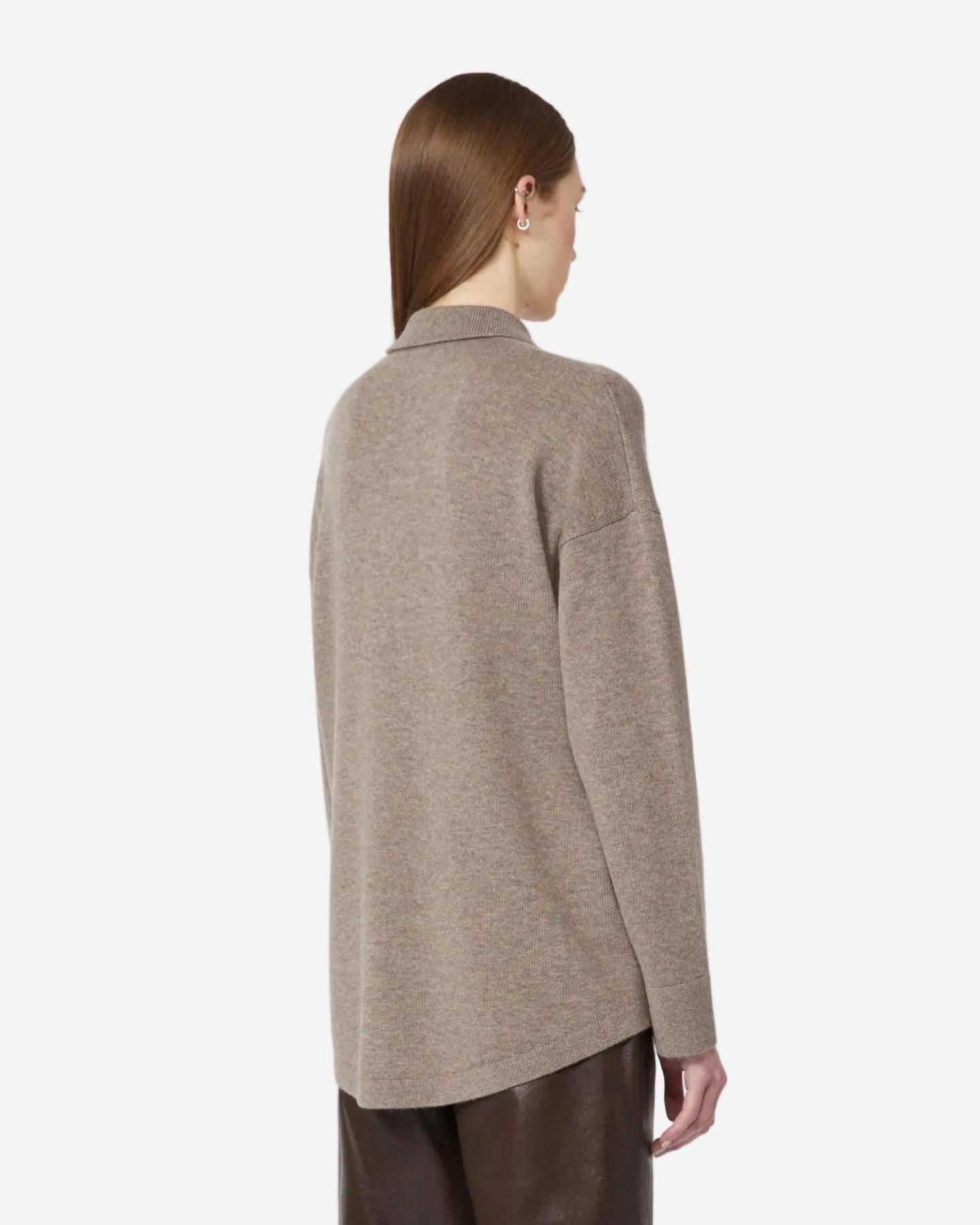 Person wearing a beige sweater on a white background