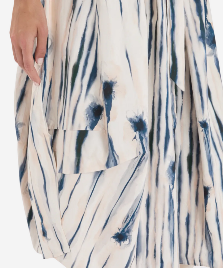 White garment with blue abstract pattern on a white background
