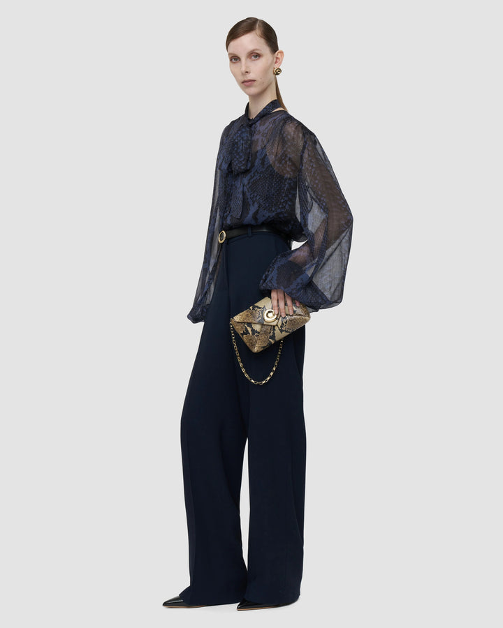 Model wearing the JOSEPH Sally snake print blouse with the JOSEPH Mitae wide-leg trousers in Prussian blue