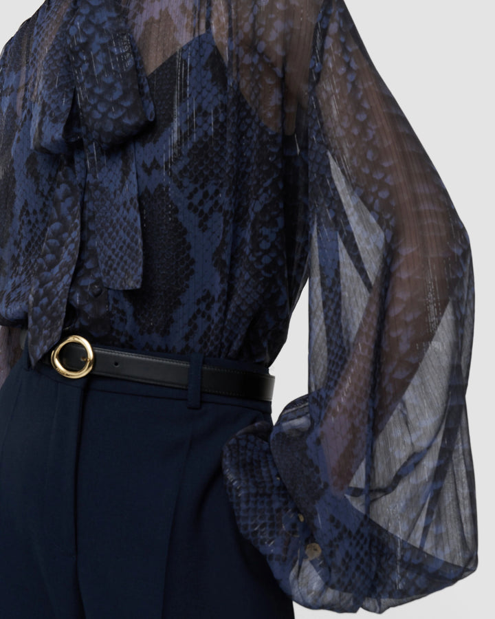 Close-up of the blouson sleeve and lurex-threaded snake print chiffon on the JOSEPH Sally blouse
