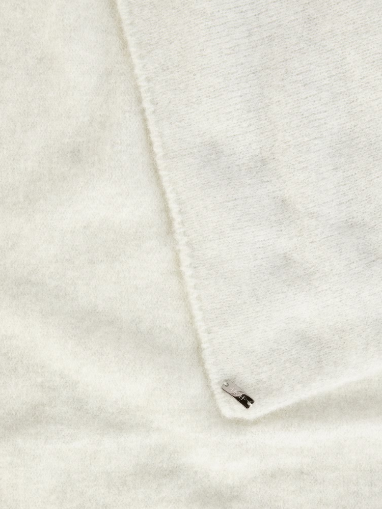 Close-up of a white fabric with a small black label.