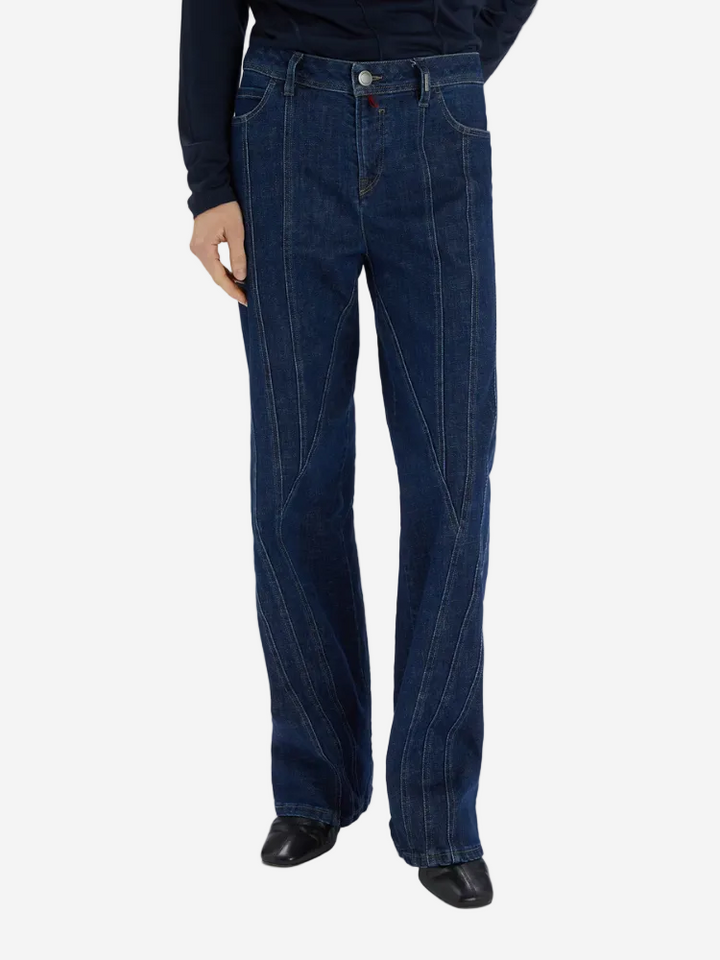 Person wearing dark blue jeans on a white background