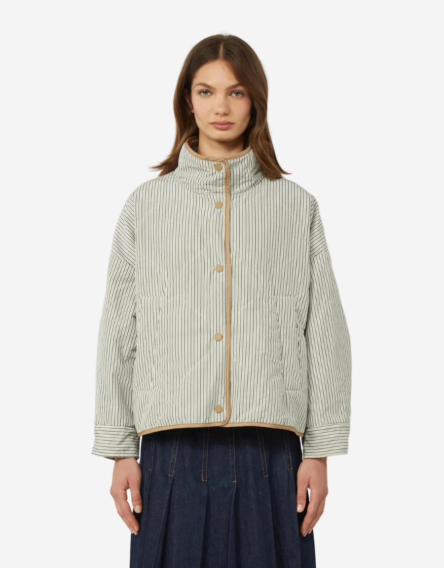 Woman wearing a green and white striped jacket on a white background