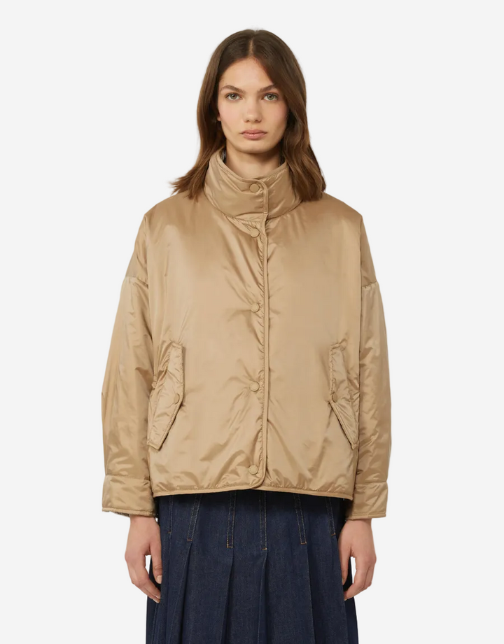 Woman wearing a beige jacket on a white background