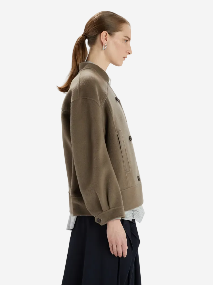 Woman wearing a brown jacket on a white background