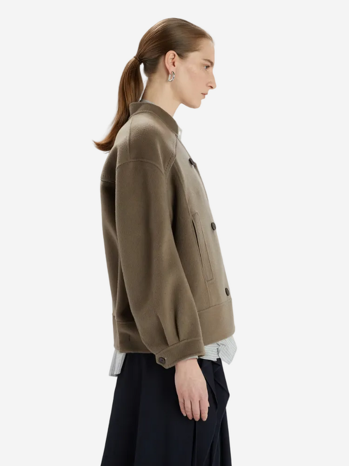 Woman wearing a brown jacket on a white background